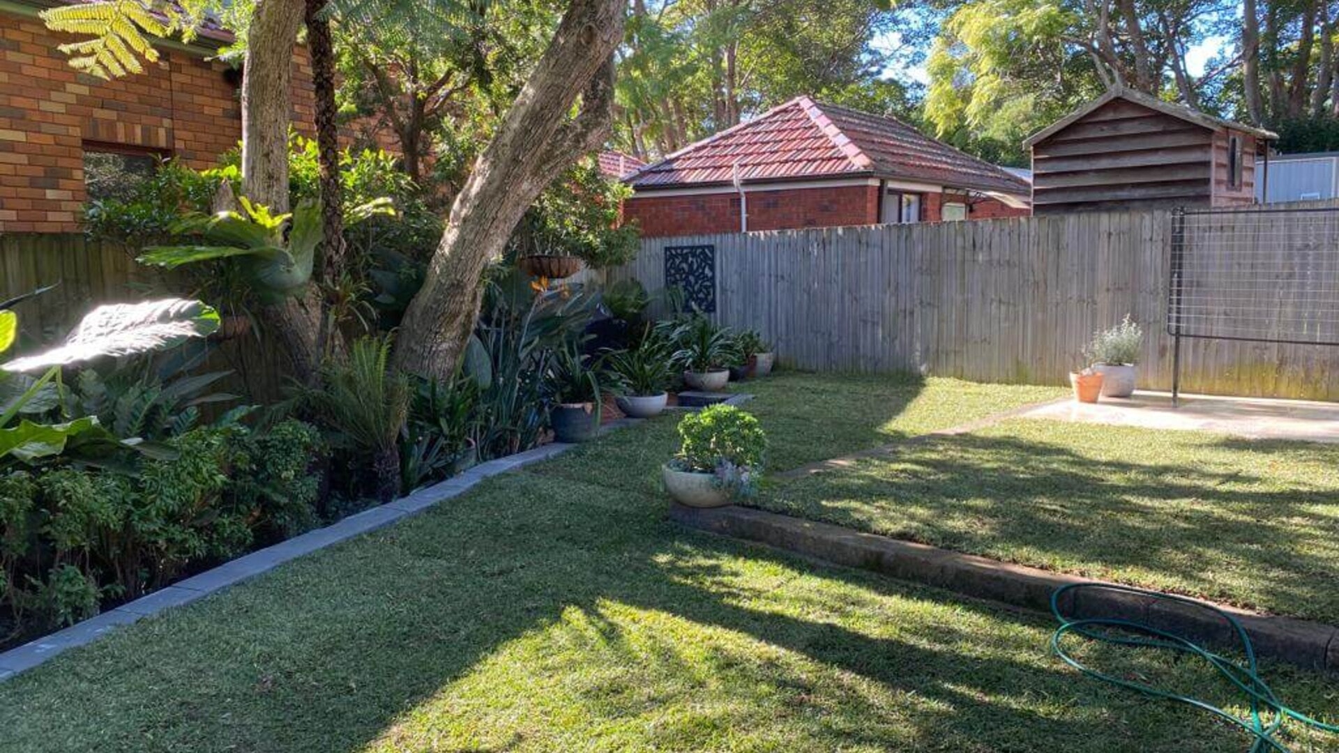 Finished Davidson yard with new lawn and paved outdoor area