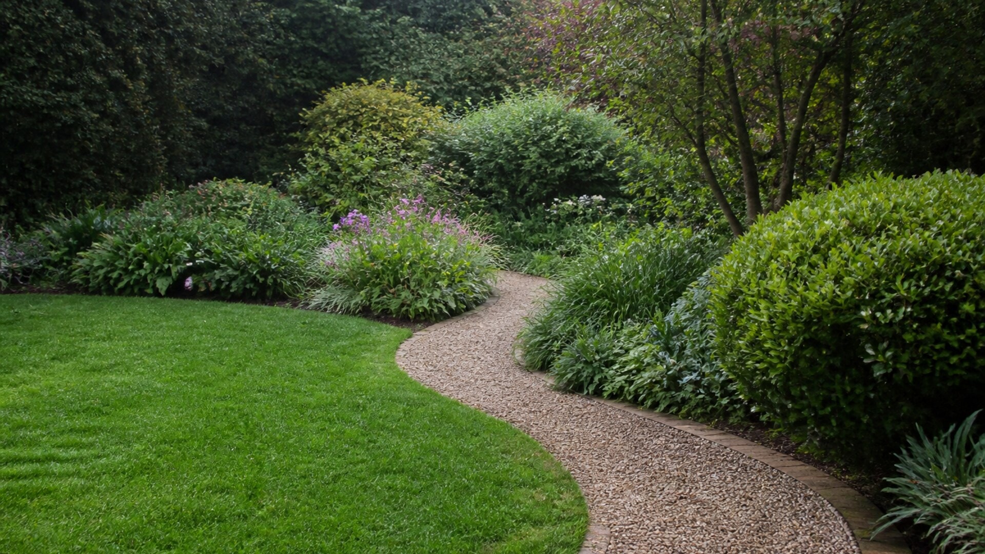 Established garden with maintained lawn, shrubs, beds and path