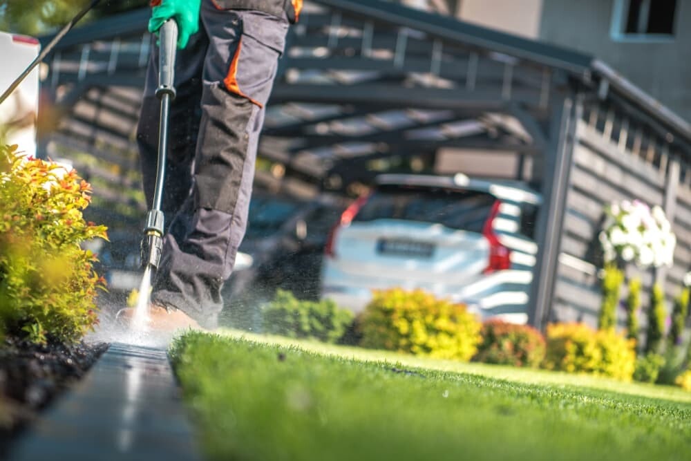 Outdoor path being cleaned with a pressure washer