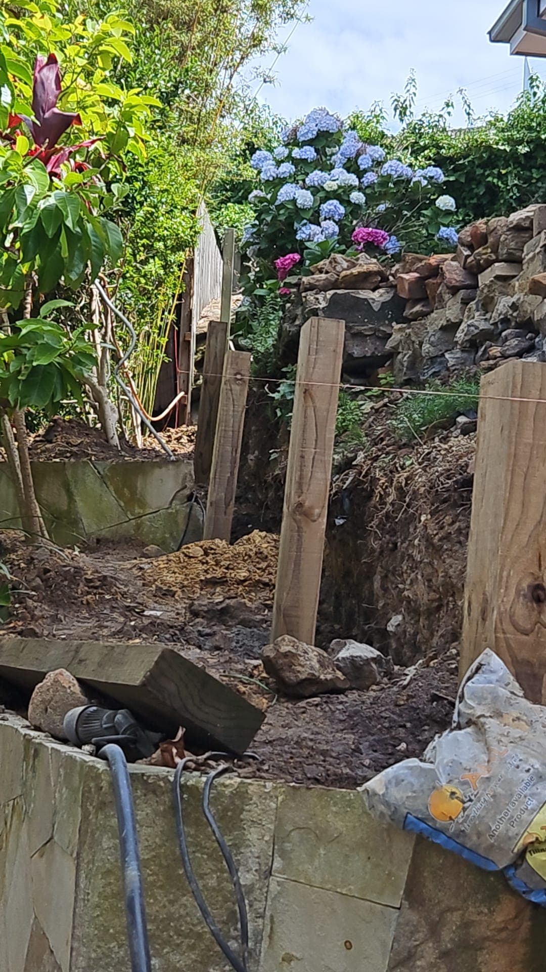 Retaining wall alignment set into the steep slope