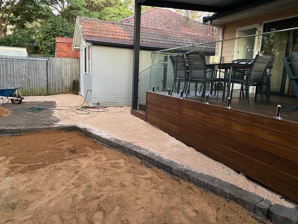 New paved seating area taking shape beside the lawn