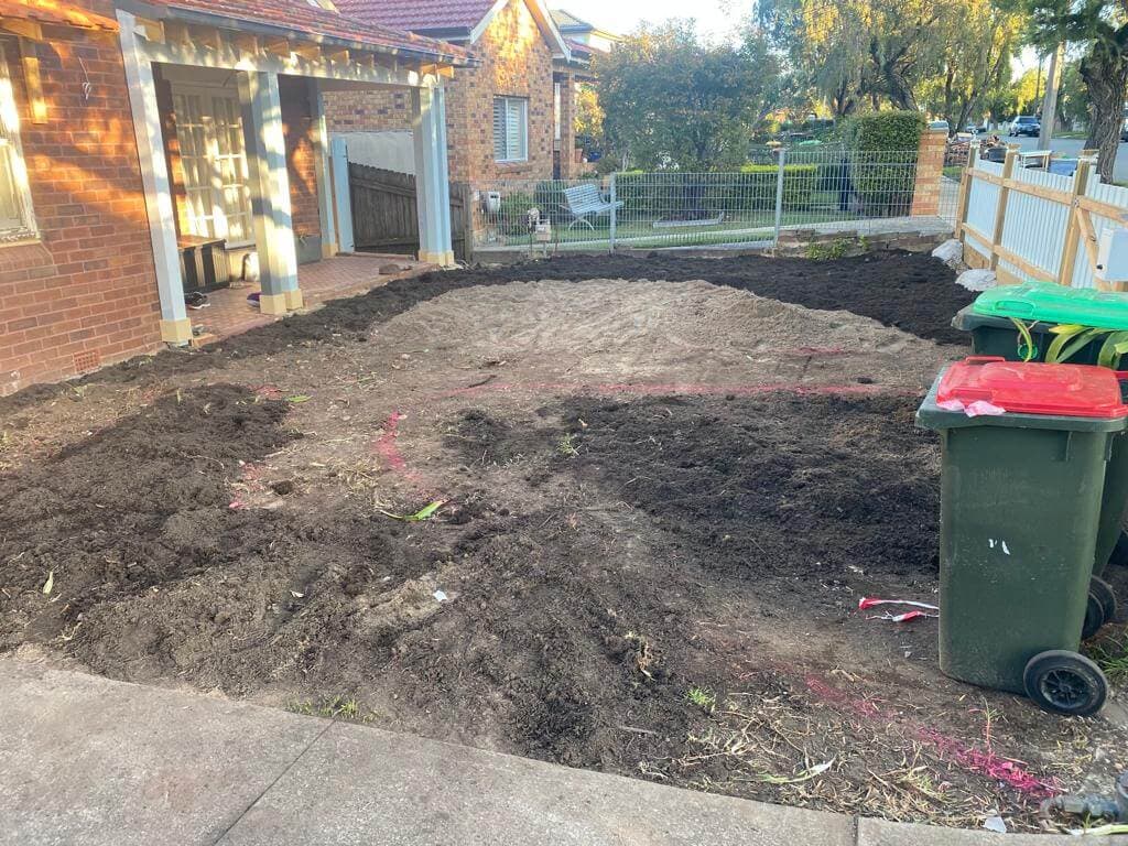 Garden area prepared before turf, beds, and paths were installed