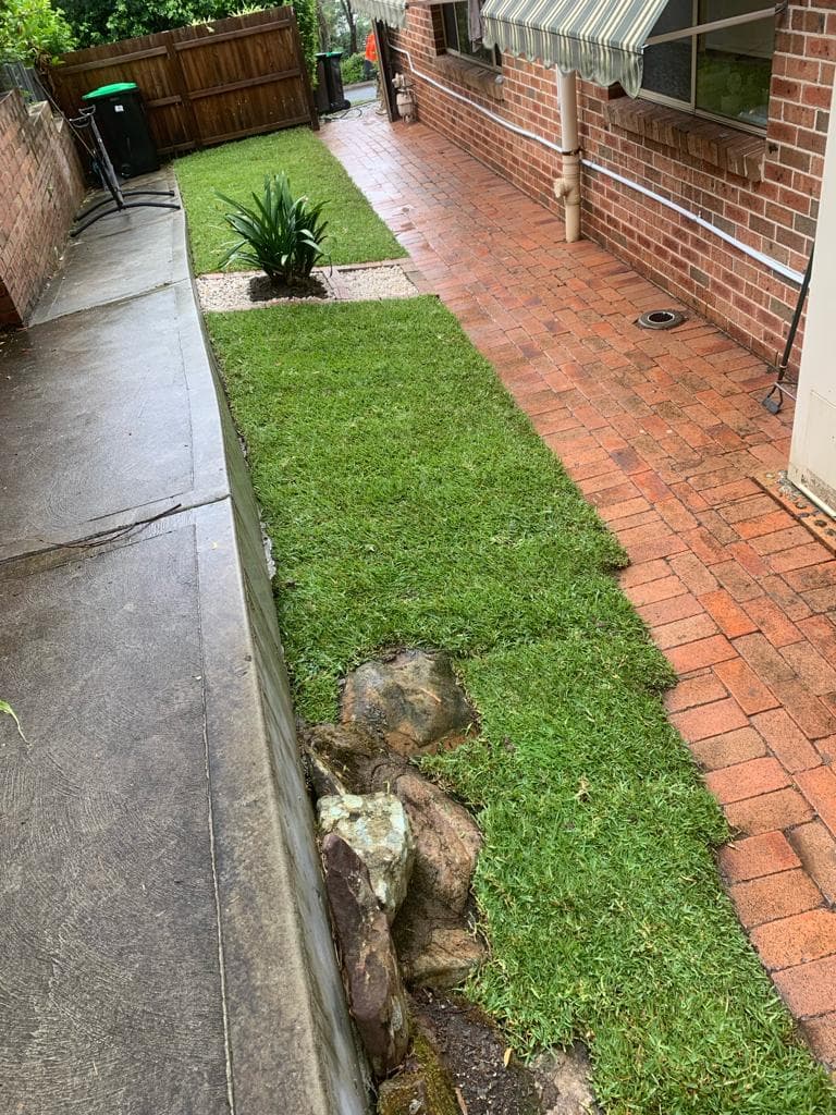White pebble finish beside the new turf