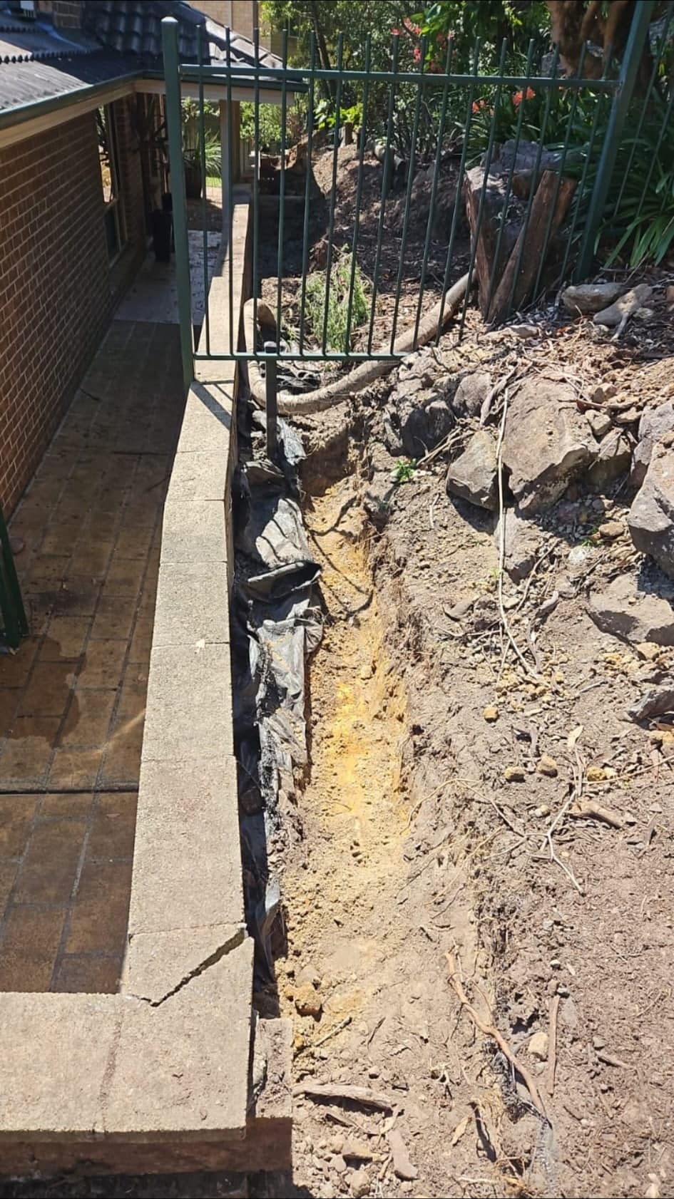Cracked besser block wall showing failure before rebuild