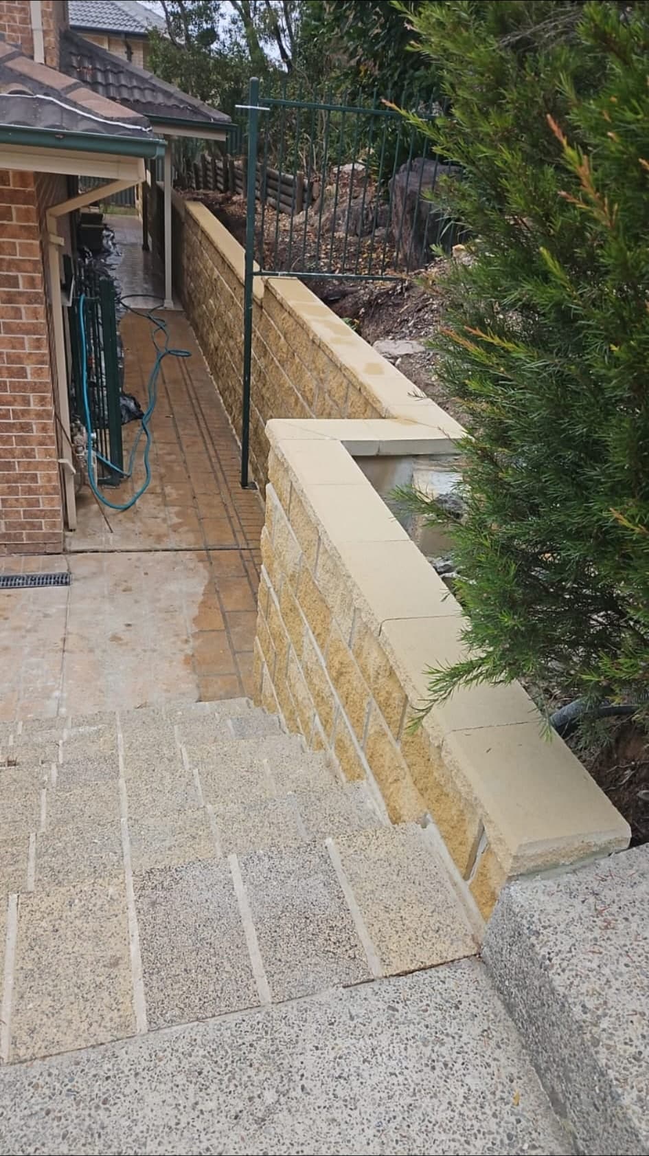 New matching-style block wall nearing completion