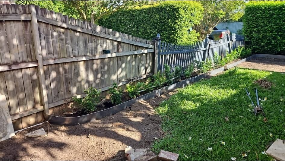 Corten steel edging installed around the garden bed
