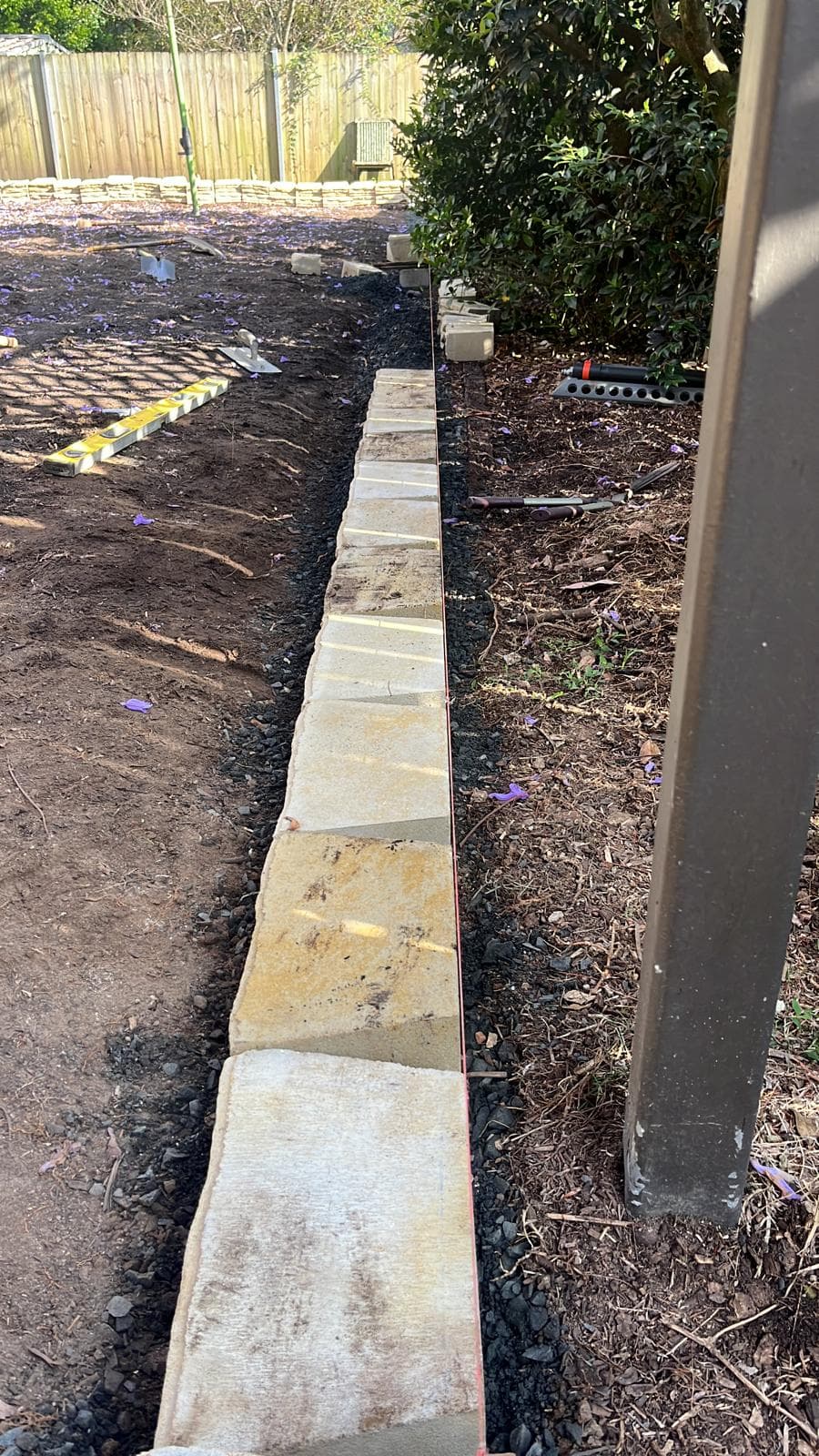 Old grass and loose garden bed edges before the work