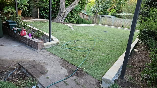 Fresh turf laid against the new garden edging