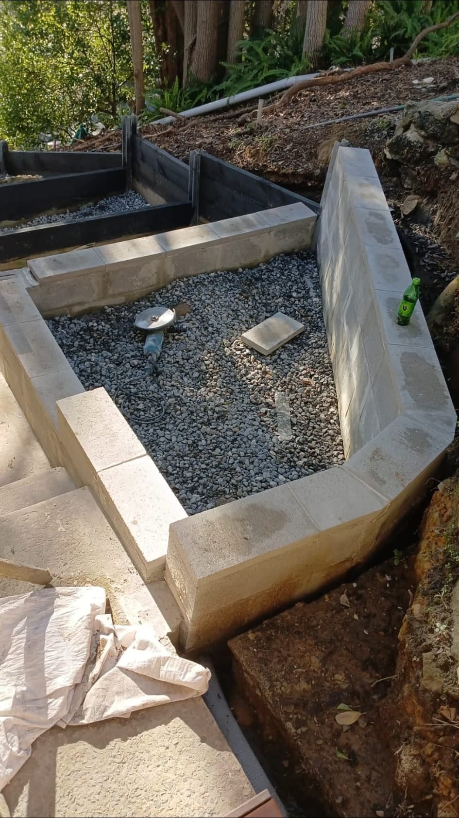 Concrete block retaining walls under construction on a steep Mosman garden