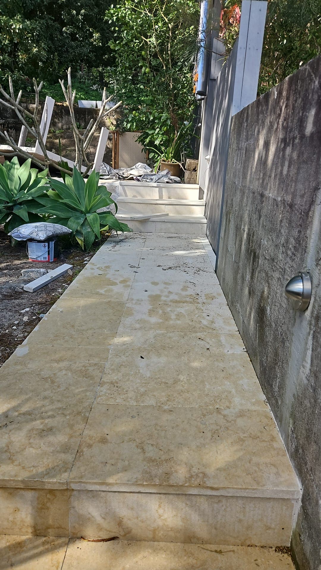 Replacement paving and wall cladding underway in the side passage