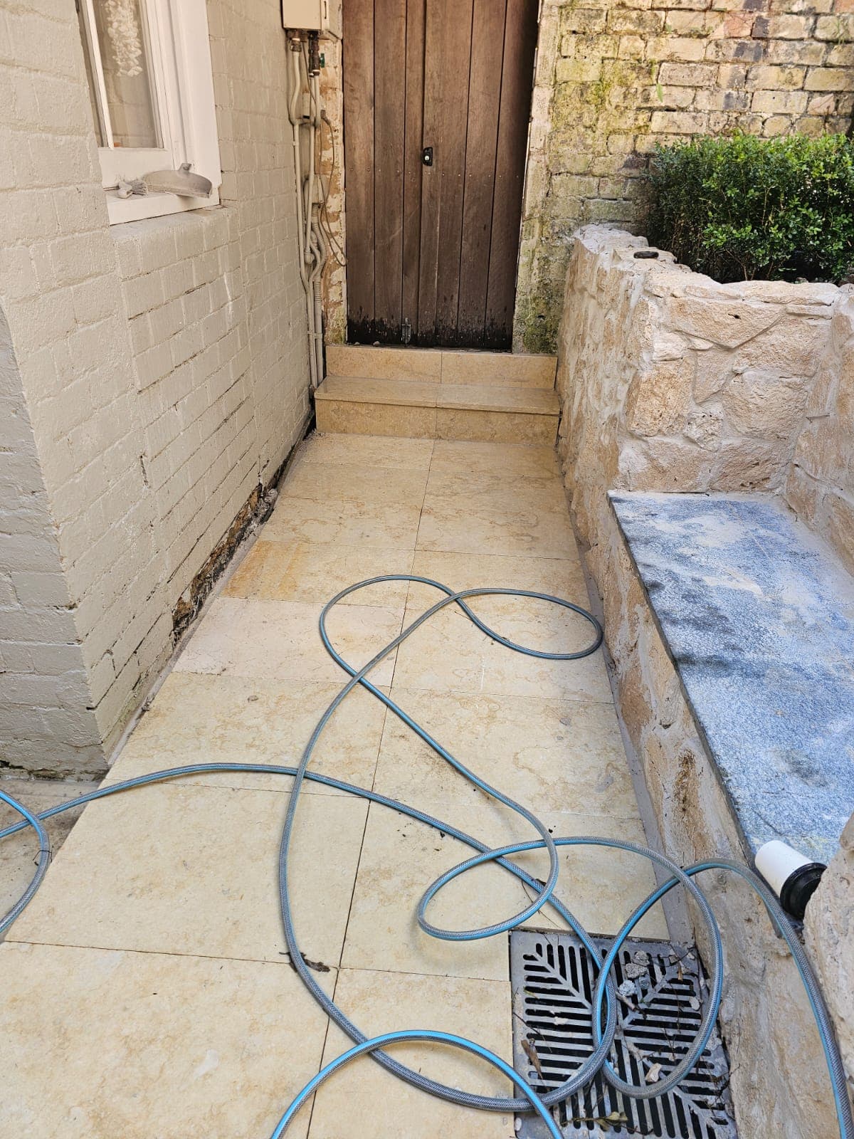 Completed paving around the drain and wall cladding