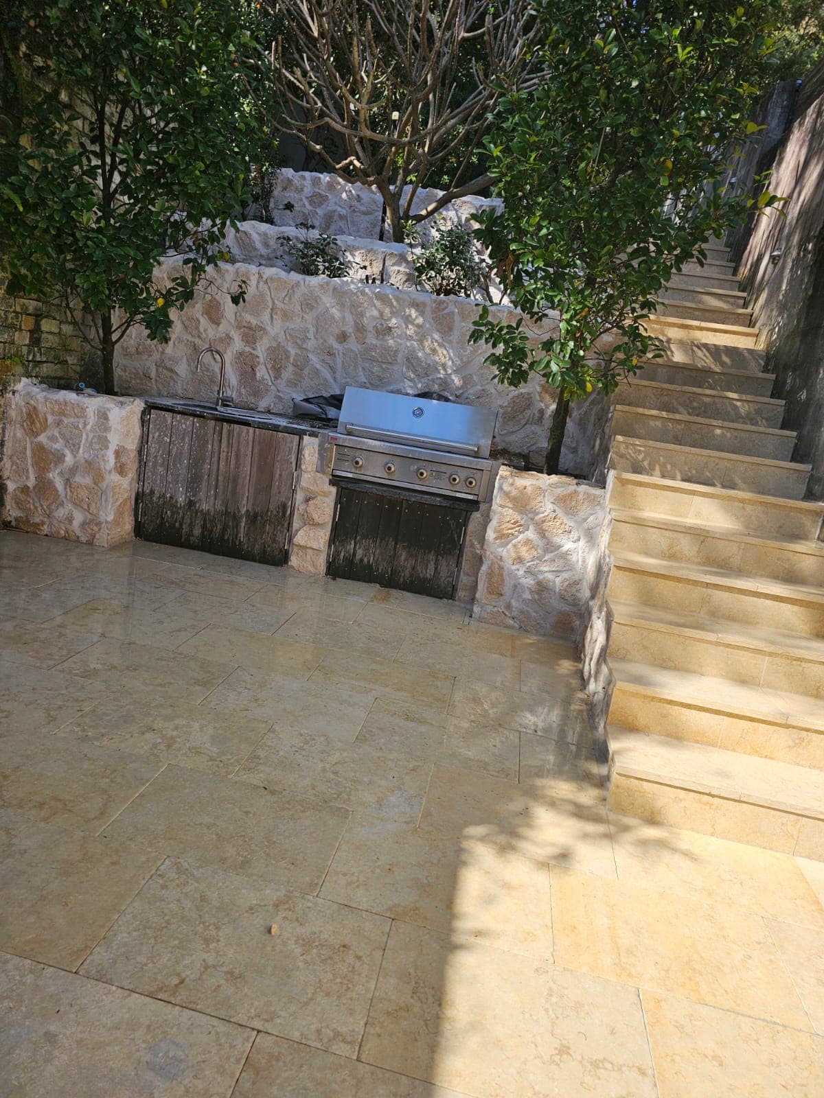 Completed courtyard, clad retaining walls and paved steps