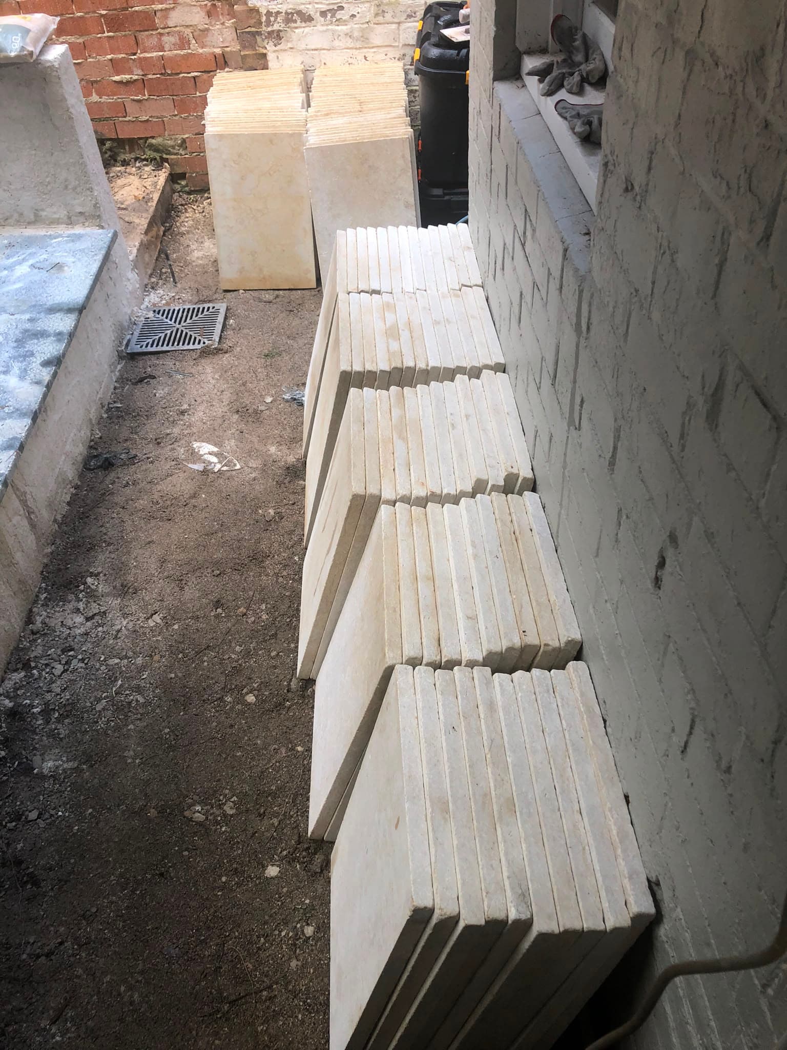 Replacement pavers stacked along the side passage