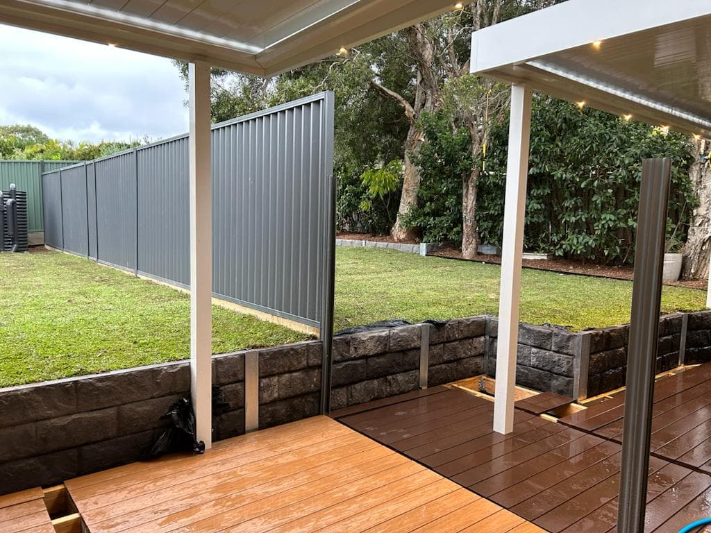 Finished Ryde yard with sleeper wall, turf, and edging